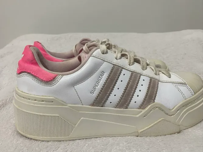 tênis plataforma Adidas Originals Superstar com detalhe rosa no calcanhar.