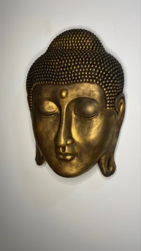 Buda em gesso , face bronze de parede .