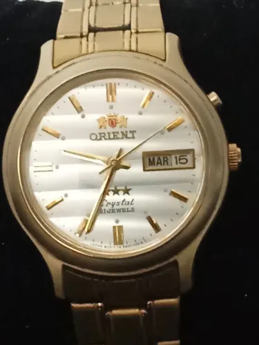 relógio orient automático modelo em02 cor dourada
