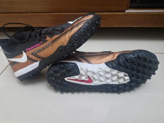 Chuteira Nike Phantom GT2 Society na cor preta com detalhes em bronze/cobre