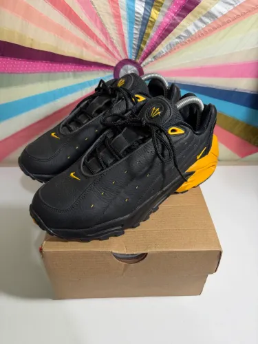 NOCTA x Nike Hot Step Air Terra Black and University Gold