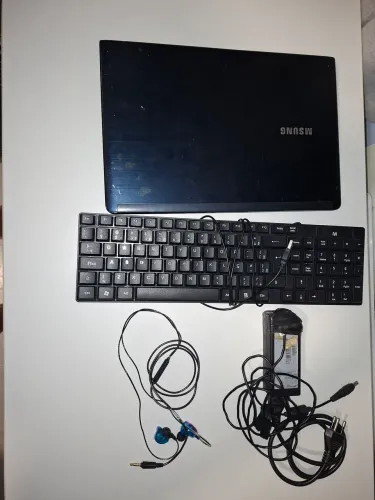 Notebook Samsung, com processador I5, acompanhado de teclado externo e fone de ouvido.