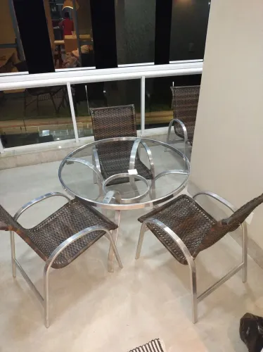 Mesa de alumínio com tampo de vidro.