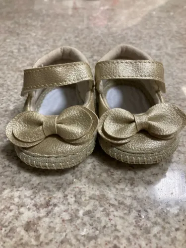 Sapatos de bebê dourados com laço