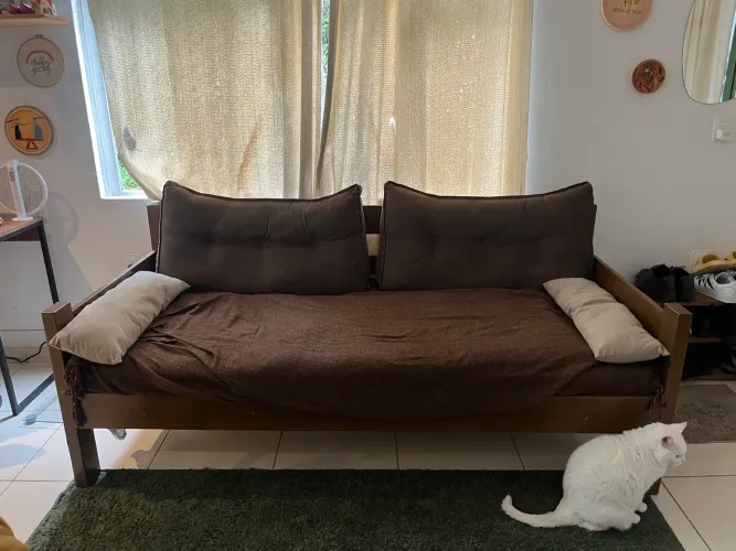 Sofá-cama de madeira, com almofadas e colchão inclusos