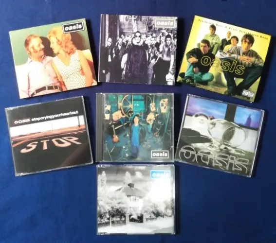 Pack OASIS CDs com 6 SINGLES IMPORTADOS (UK-JAPÃO) + 1 Livro de Entrevistas c/CD RARIDADES
