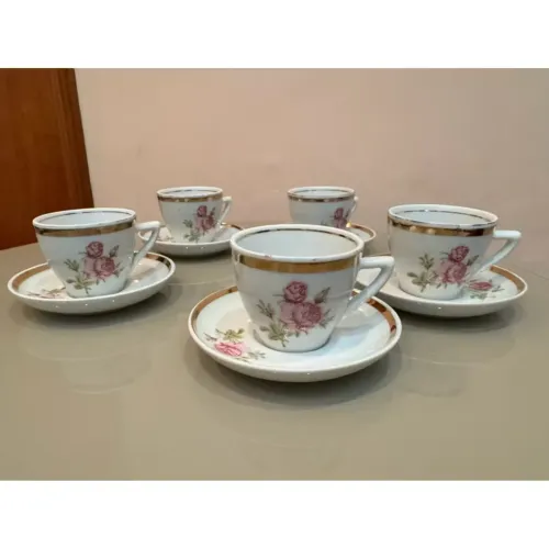 Conjunto de xícaras e pires de porcelana antigos com detalhes florais e dourados