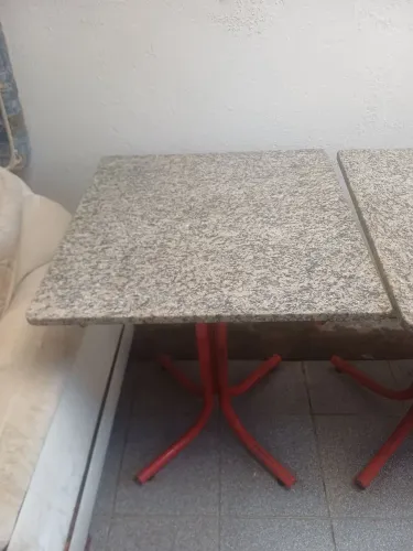 Mesa com tampo de granito e estrutura vermelha