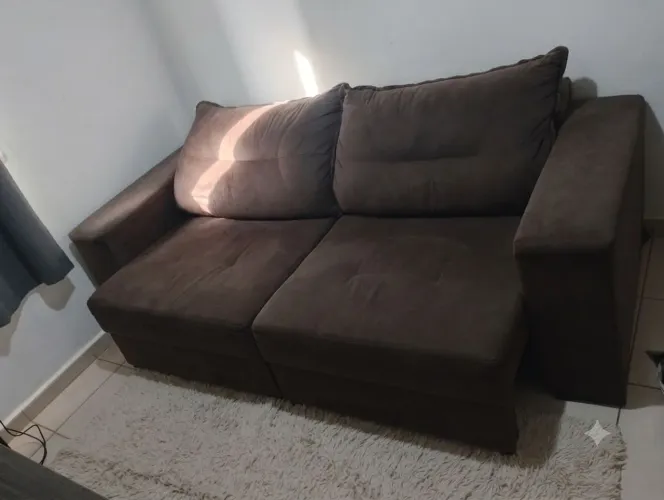 Sofá usado tem alguns detalhes e um sofá usado