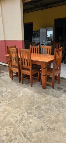 Mesa de madeira com 6 cadeiras de madeira.