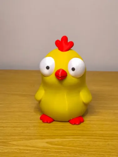 Miniatura de pintinho amarelo com olhos gigantes