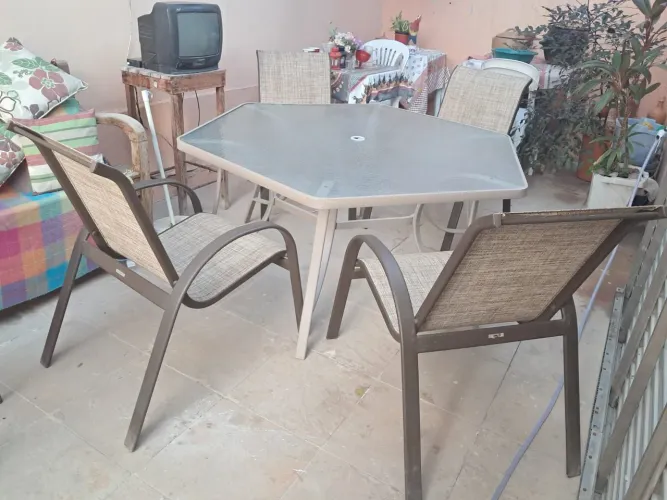 Vendo um conjunto de mesa de vidro grande com quatro cadeiras para jardim.ou piscina,