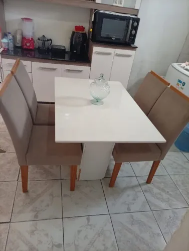Mesa de 4 lugares com tampo de vidro.