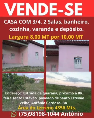 Uma casa com uma área de terra e vários pés de frutas