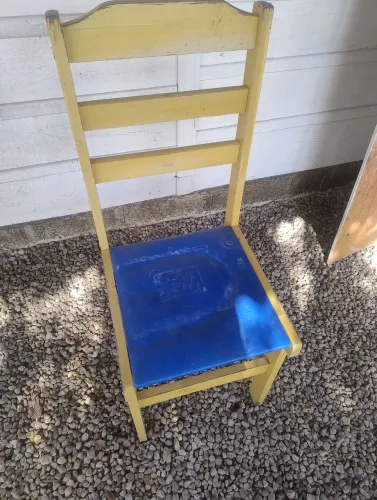 Cadeira de madeira amarela com assento azul