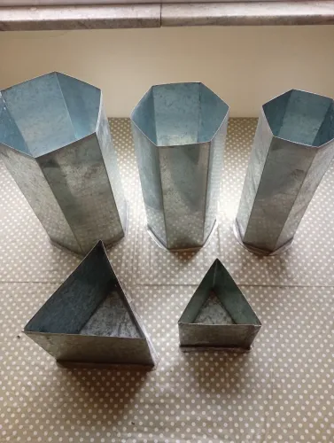 Diversas formas e tamanhos de vela em metal galvanizado