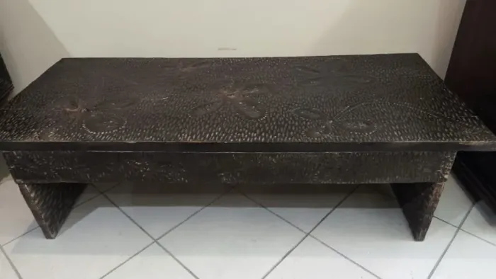 Mesa de centro antiga em madeira entalhada à mão, com padrão decorativo floral