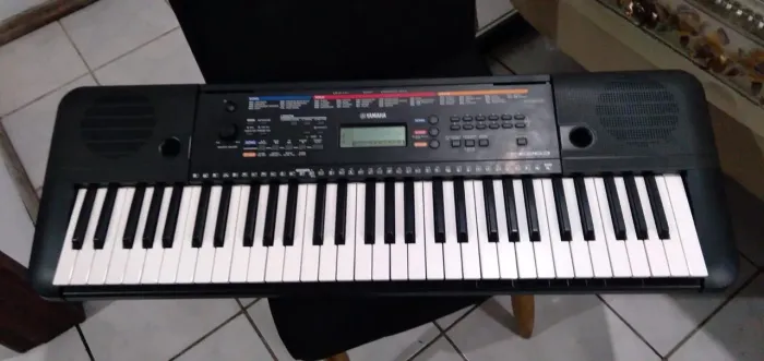 Teclado Yamaha PSR e263, com suporte original e capa.