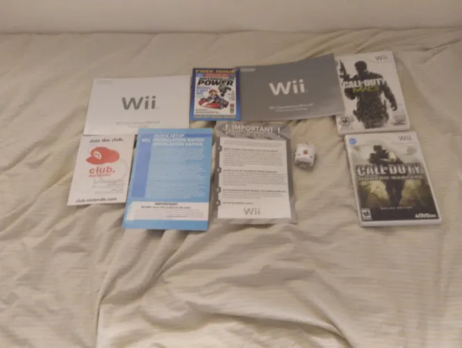 Lote de manuais + jogos + acessório de wii