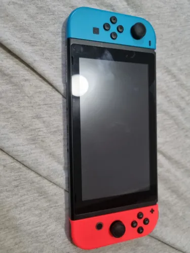 Nintendo Switch V1 com 26gb de armazenamento junto com lego jurrasic world e uma bolsa