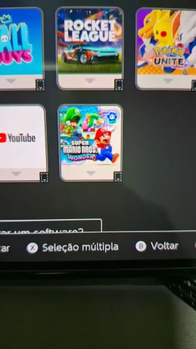 Nintendo switch oled com dois jogos super Mario Wonder e dragões Ball fighterz