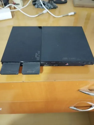 PlayStation 2 preto com caixa, manuais e acessórios