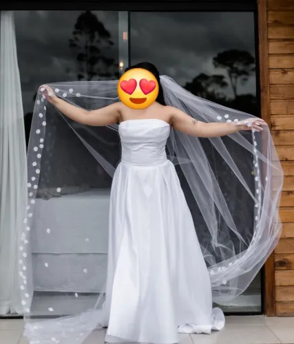 Vestido de noiva branco com véu. 