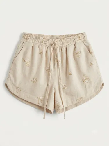 shorts bege com bordados de borboletas