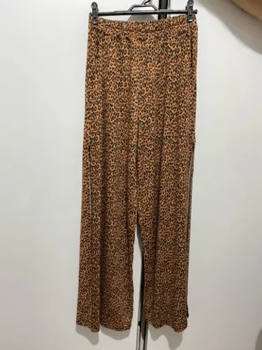 Calça pantalona com fenda oncinha.