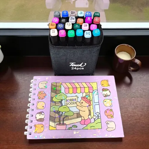 Kit livro Bobbie Goods Roxo + 24 canetinhas para colorir