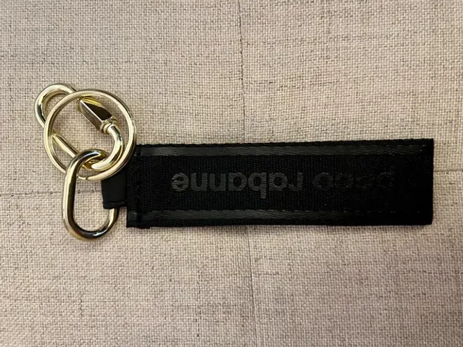 Chaveiro em tecido e metal dourado original Paco Rabanne novo