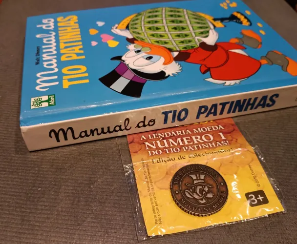 Moeda n° 1 do Tio Patinhas com Manual do Tio Patinhas