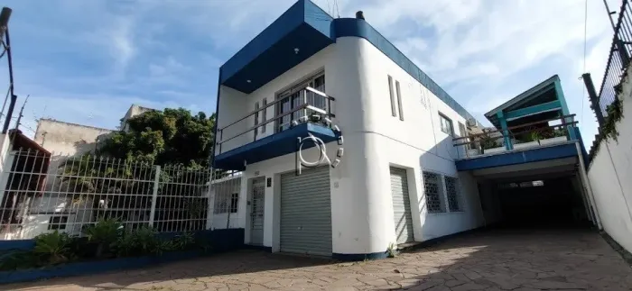 Prédio comercial com apartamento e loja para alugar no bairro Nonoai.