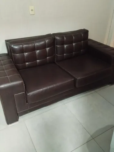 Sofá marrom em couro sintético.