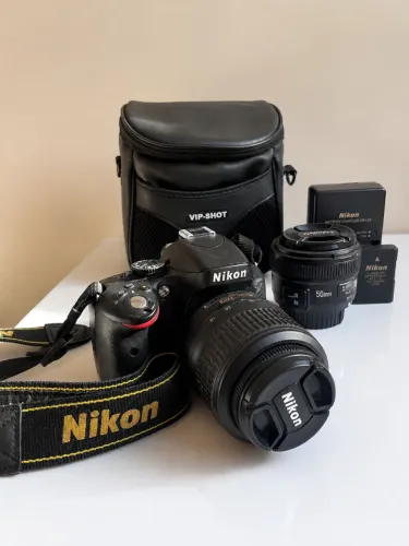 Nikon D5100 + Lente 18-55mm VR + Yongnuo 50mm f/1.8 + Tripé + Bolsa
