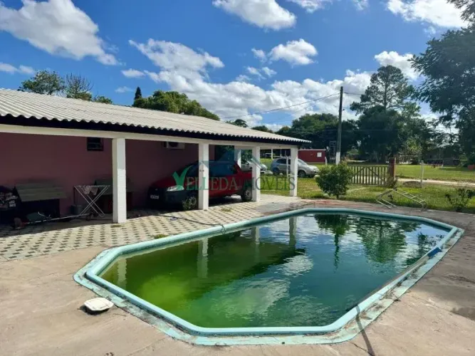 Sítio com duas casas e piscina em condomínio fechado na faixa da RS040