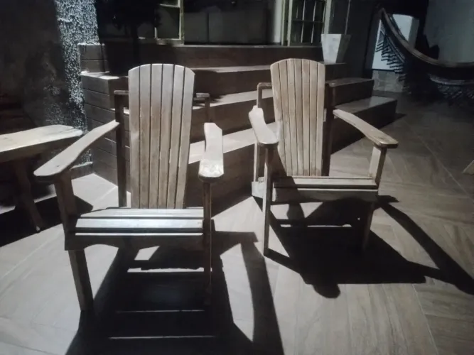 Cadeiras Adirondack em madeira rústica.