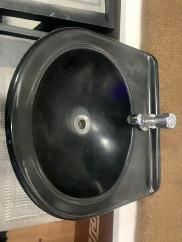 Lavatório de Banheiro Preto com torneira.