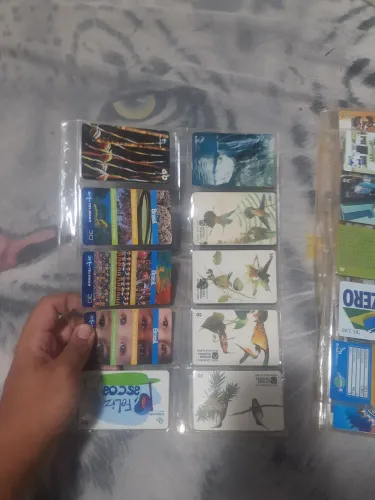 Cartelas com cartões telefônicos antigos