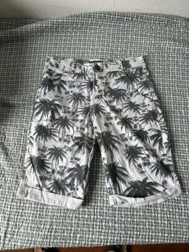 Bermuda branca com estampas de coqueiro