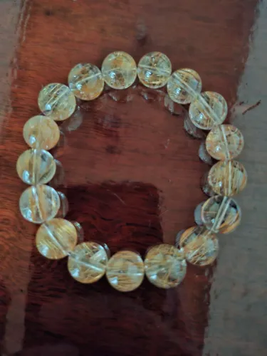 Pulseira de Quartzo Rutilado, com esferas de 15mm e 17 esferas.