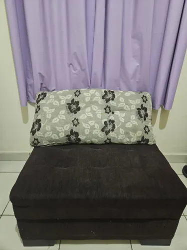 Dois sofás marrons acompanhando almofadas