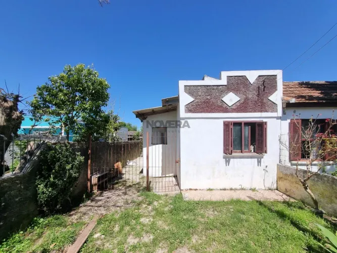 Terreno com casa por finalizar em rua asfaltada no bairro Santa Terezinha