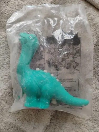 Dinossauro McDonald's coleção McDinos lacrado com esqueleto fosforescente