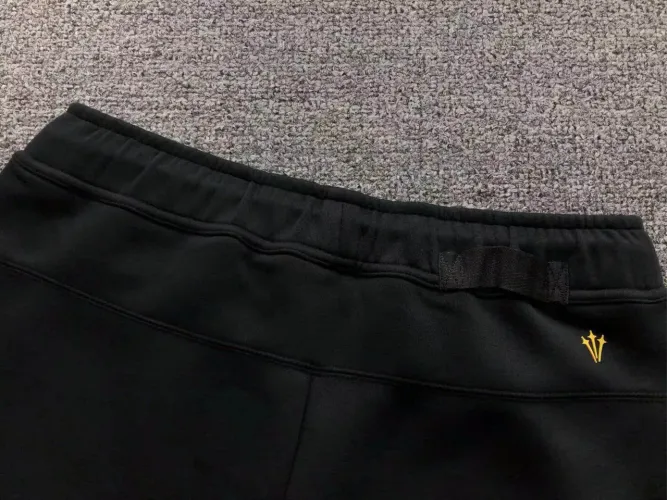 NOCTA x Nike Calça Tech Fleece Black University Gold
