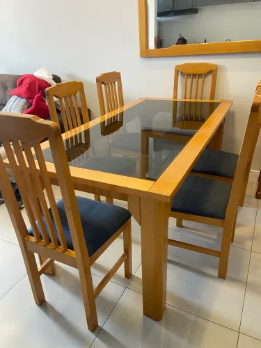 mesa de madeira com 6 cadeiras e espelho.