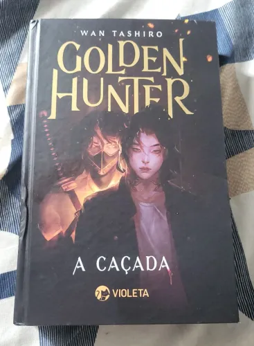 LIVRO CAPA DURA GOLDEN HUNTER A CAÇADA DE WAN TASHIRO