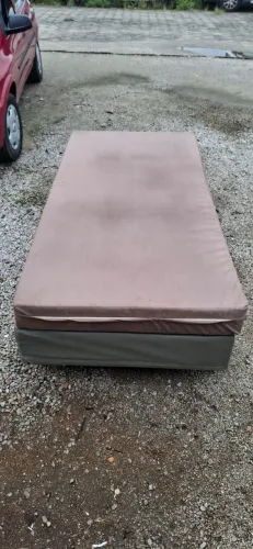 Cama de solteiro com colchão marrom, em bom estado.