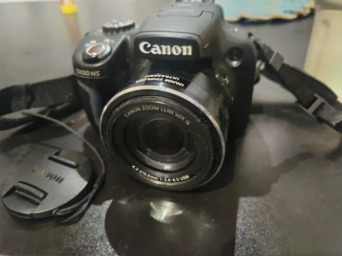 Câmera Canon PowerShot X50 HS com proteção de lente e carregador 