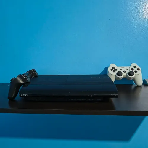 PS3 com dois controles e jogos